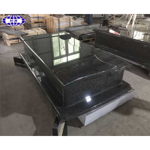 large black granite headstone with sculpture